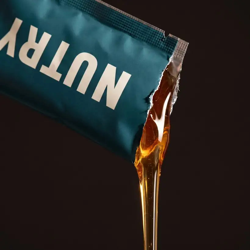 Honey pouring from a torn Nutry sachet