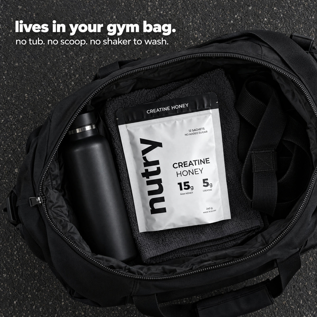 Lives in your gym bag: a Nutry Creatine Honey pouch inside an open gym bag. No tub, no scoop, no shaker to wash.